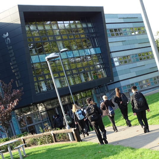 Group of students walking outside a modern building