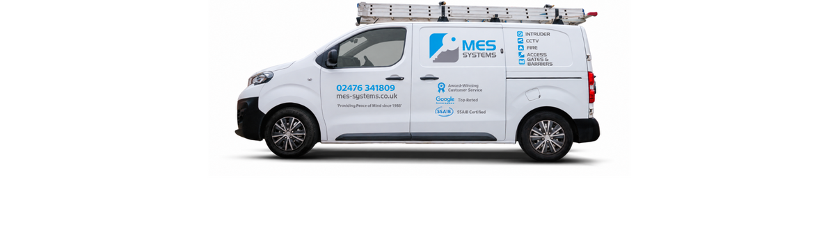 A white MES systems van featuring a roof rack and ladder is shown against a plain white background.
