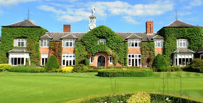The Belfry hotel with greenery and a clear blue sky