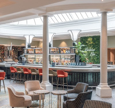 Modern bar area with seating and a large window