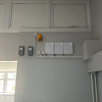 Access control electrical panel with multiple switches and outlets on a wall.